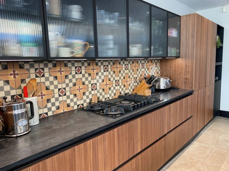 Walnut and black finish kitchen by Next 125 with tall units and statement island